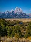 The Grand Tetons rise high over the Snake River valley in Wyoming. Art Print